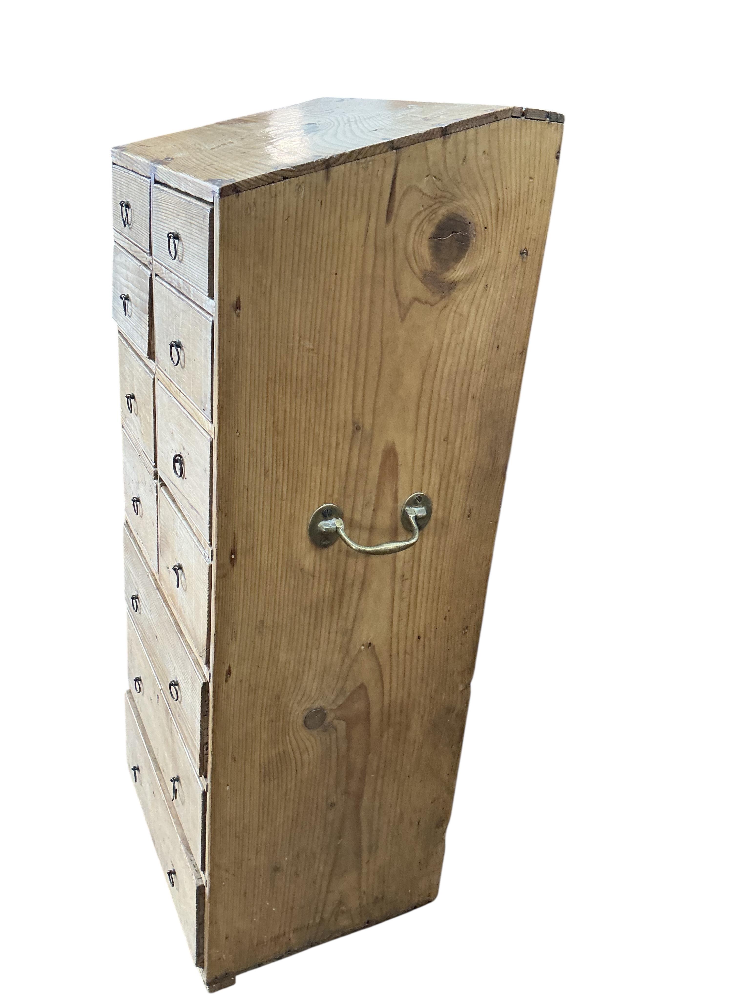 An early 19th century pine eleven drawer campaign chest with slant top, width 33cm, depth 26cm, height 80cm